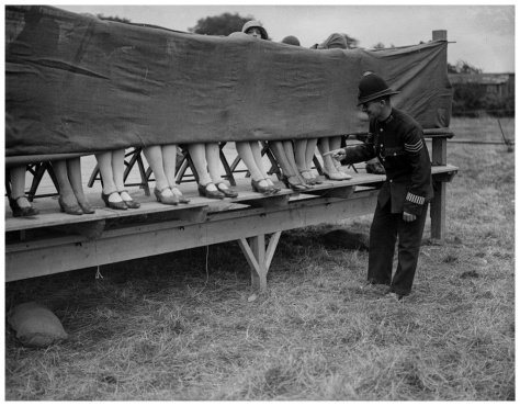 A policeman judges an ankle competition